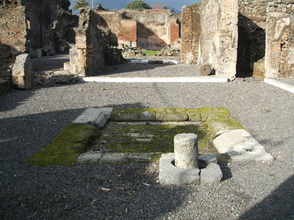 VI.13.2 Pompeii. December 2004. Atrium and impluvium. On 13th September 1943 at 17.00 hours much damage was done when two bombs landed here. 
One caused the demolition and destruction of three rooms on the west side of the atrium, with a large part of the perimeter wall onto Vicolo del Fauno. The other damaged another three rooms on the south-east side, together with the perimeter wall on the east side.  The south-west of the peristyle was also destroyed together with surrounding areas, including the lararium on the east side.
See Garcia y Garcia, L., 2006. Danni di guerra a Pompei. Rome: L’Erma di Bretschneider. (p. 85)