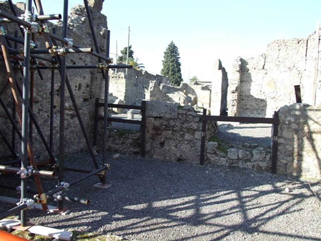VI.13.3 Pompeii. December 2007. Looking towards north wall of shop.
Doorway on left led to the atrium of VI.13.2.  Doorway on right led to a cubiculum of VI.13.2.