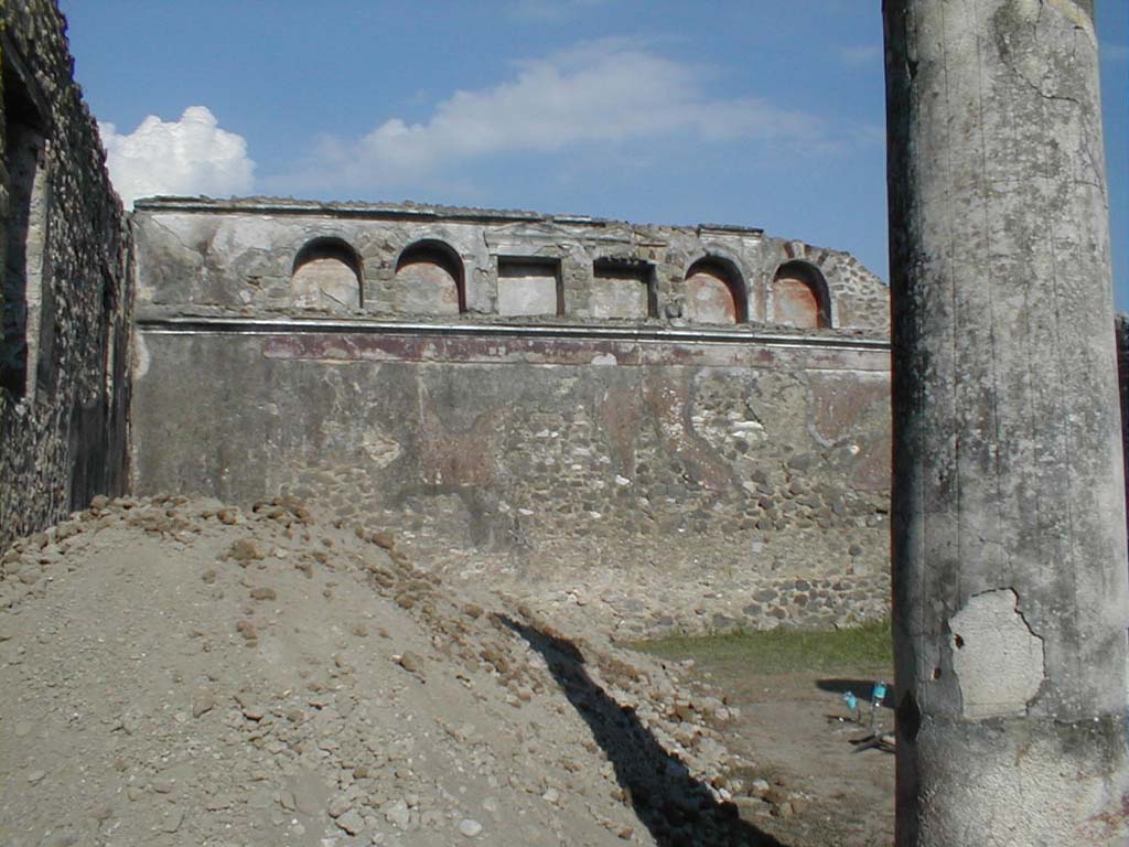 VI.13.19 Pompeii. September 2005. Looking east across garden area towards rear wall, with six niches high up in the wall.
According to Jashemski, the rear wall had an animal painting on the wall, now totally destroyed.
A terracotta statue of a boy was found in one of the niches. 
Now in Naples Archaeological Museum. Inventory number: 110395.
She also said fragments of a similar statuette was found in another niche, but no further details.
See Jashemski, W. F., 1993. The Gardens of Pompeii, Volume II: Appendices. New York: Caratzas. (p.148 & p.344, no.53)