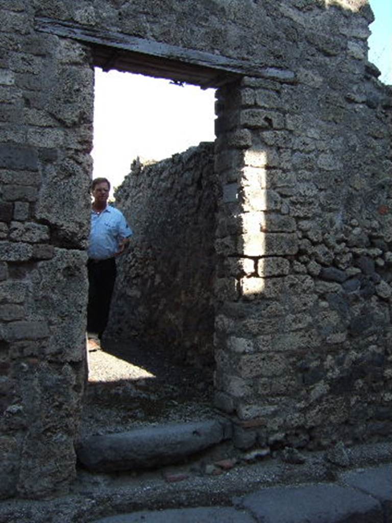 VI.13.20 Pompeii. September 2005. Entrance doorway, looking east. This exterior doorway originally only led into a room with stairs leading directly to the rooms on the upper floor.