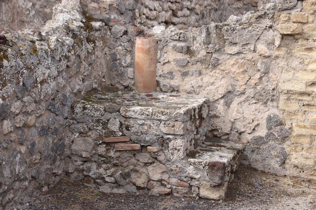 VI.14.4 Pompeii. October 2020. North-west corner with base of steps to upper floor, and downpipe at rear. Photo courtesy of Klaus Heese.