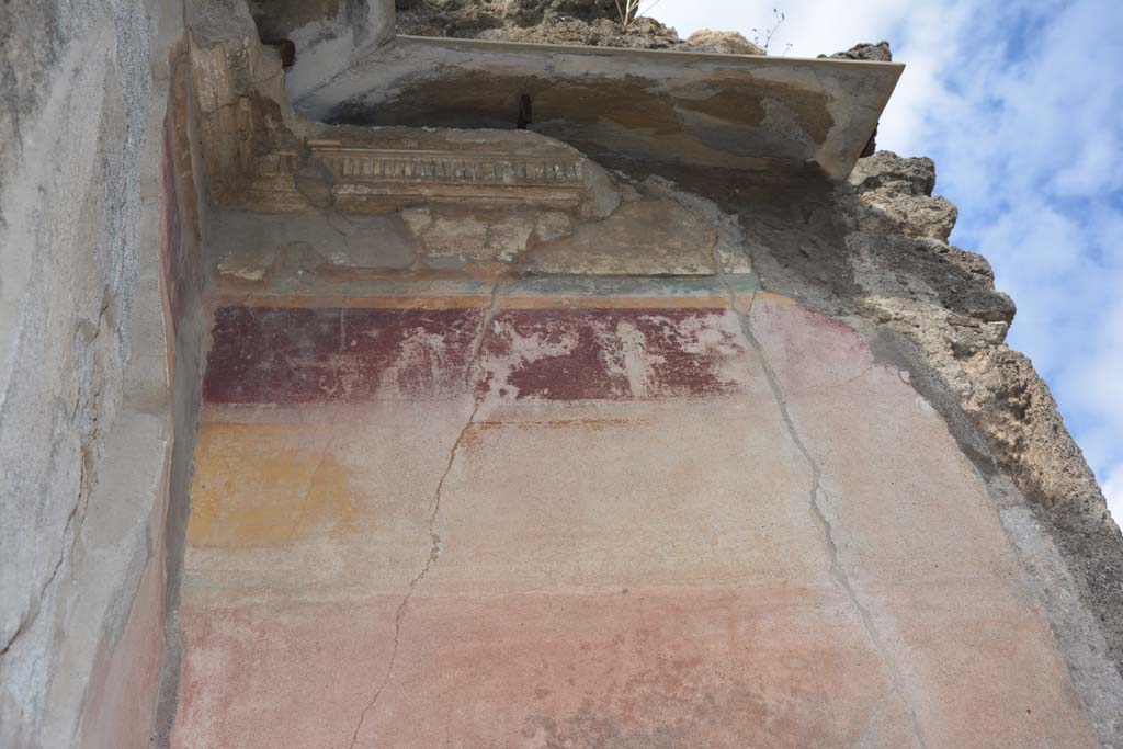 VI.14.12 Pompeii. July 2017. Detail of remaining painted stucco from west wall in south-west corner of atrium.
Foto Annette Haug, ERC Grant 681269 DÉCOR.
According to PPM –
“In the south-west corner of the atrium, the decoration remained in I Style only above the doorway to VI.14.13 in the south wall. 
On the west wall of the atrium it had been restored in III Style, with the middle zone of the wall painted red, a yellow frieze and violet with remains of a human figure.”
See Carratelli, G. P., 1990-2003. Pompei: Pitture e Mosaici. V (5). Roma: Istituto della enciclopedia italiana, (No. 5, p.250-251).