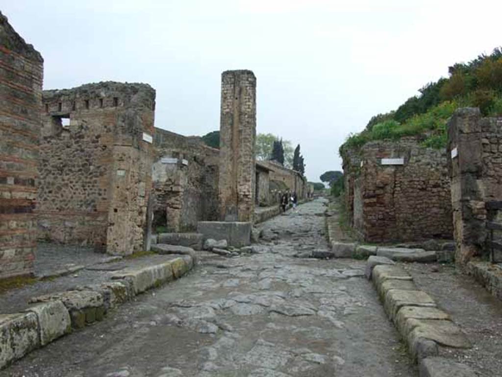VI.14.31 Pompeii. May 2010. Looking north towards middle of Via Stabiana (Via del Vesuvio) at the north east corner of VI.14. Near here the cast of the woman with her tunic raised above her head and the supine man, were made.