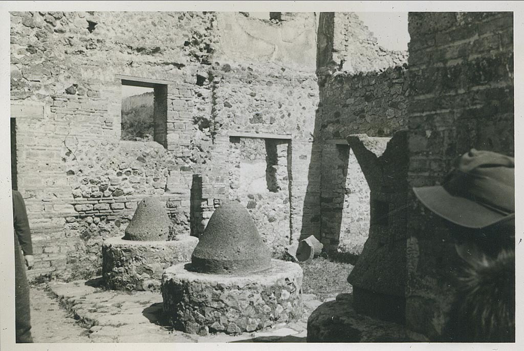 VI.14.32 Pompeii. March 1939. 
Looking north-east across mills towards room on east side of entrance doorway, and doorway connecting to VI.14.30, in centre right. 
Photo courtesy of Rick Bauer.