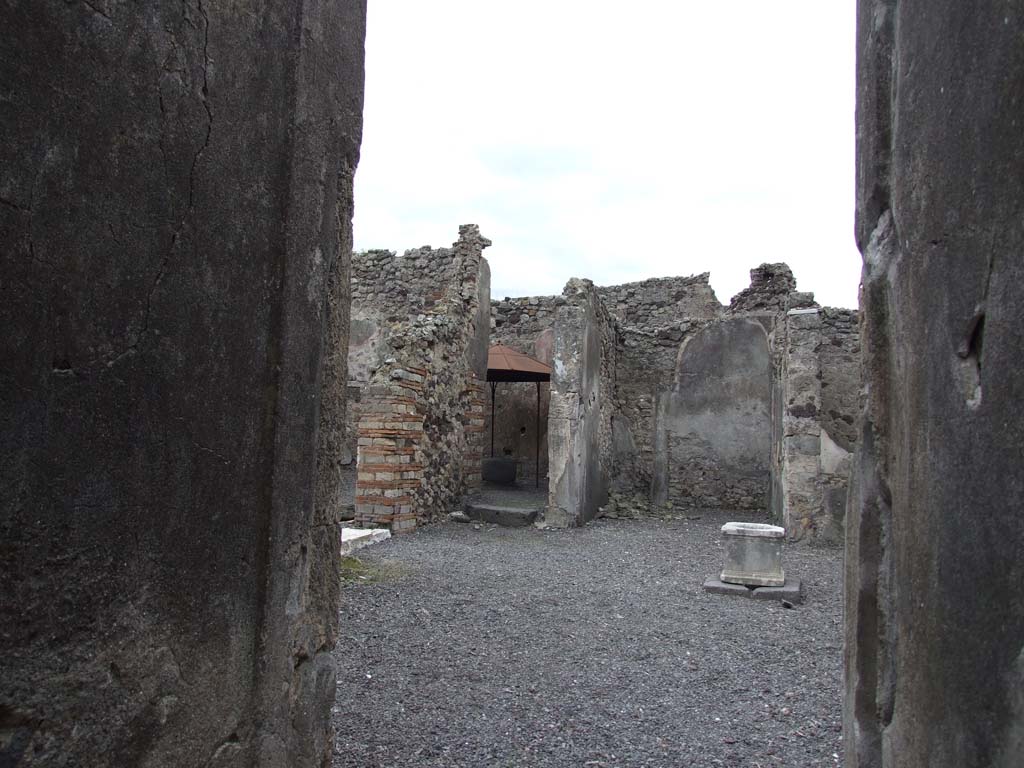 VI.14.34 Pompeii. December 2007. 
Looking south-east across atrium towards entrance to bakery with white threshold, doorway to garden-yard and doorway to tablinum, from entrance corridor.