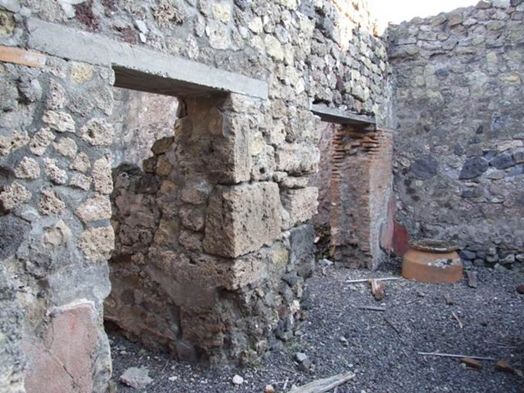 VI.14.35 Pompeii. December 2007. Two doorways in east wall.
On the left is the doorway to the kitchen and latrine, a wooden staircase at the side of the kitchen led to the upper floor.  On the right, the doorway to a room for clients.
