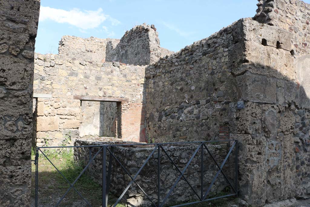 VI.14.36 Pompeii. December 2018. 
Looking south-east to entrance doorway on east side of Vicolo dei Vettii.  Photo courtesy of Aude Durand.