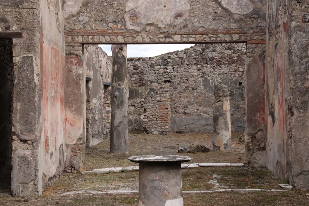 VI.14.40 Pompeii. October 2020. Looking east towards tablinum and peristyle. Photo courtesy of Klaus Heese.  
According to Kuivalainen – 
In the tablinum “The zoccolo/dado was black with floral motifs, the central zone was red with panels divided with bands, and between the fields were candelabra with twining plants. The upper zone had a white background.
On the upper north wall, but nearly destroyed, was a painted youth (a young, almost naked Bacchus) …… On the other walls Apollo and Ceres were painted.”
Description: A youth standing with his weight on his left foot, wearing yellow boots, a red cloak covering his back and forearms; a band from the right shoulder goes to the left hip. On his head is a vine wreath. In his right hand he holds a cantharus, in his left a thyrsus.
Comments: Young almost naked Bacchus. The band is rare, the boots or high footwear are more common.
See Kuivalainen, I., 2021. The Portrayal of Pompeian Bacchus. Commentationes Humanarum Litterarum 140. Helsinki: Finnish Society of Sciences and Letters, p.97, B5.
