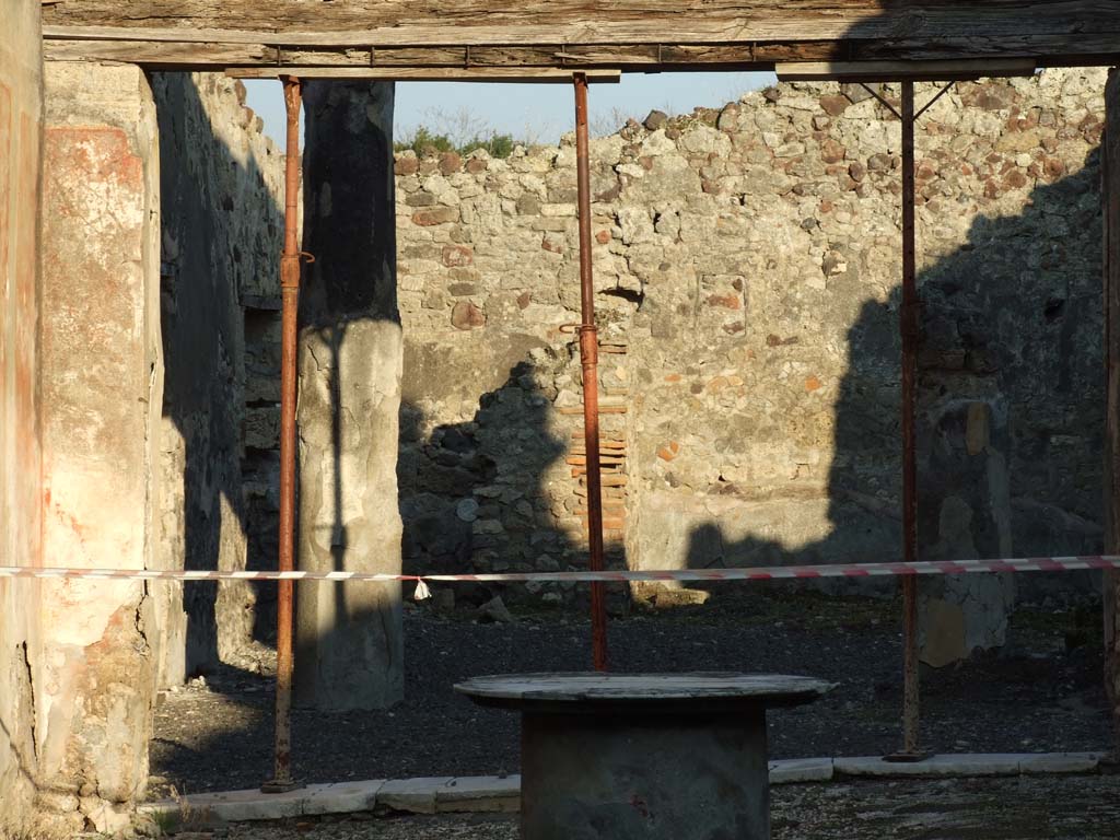 VI.14.40 Pompeii. December 2007. Peristyle on east side of tablinum.  
According to Jashemski, the peristyle garden at the rear of the tablinum was visible from the entrance doorway.
It was enclosed on most of the north and part of the south sides by narrow passageways.
On the west side by a wide portico supported by two stuccoed columns, yellow to a height of I.86m, red above.
The side passages were covered by overhanging roofs from the adjacent rooms.
The triclinium on the left had a large window looking into the garden.
On the right of the garden, a statuette of a small boy holding a little dog, was found.
The front legs of the dog were missing, as were also the legs of the boy from the knees down.
A rectangular base with a portion of the feet was found.
Now in Naples Archaeological Museum, inventory number 120511.
See Jashemski, W. F., 1993. The Gardens of Pompeii, Volume II: Appendices. New York: Caratzas. (p.151)