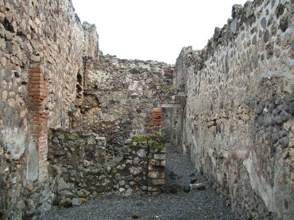 VI.14.41 Pompeii. December 2004. Looking east across workshop towards corridor to rear, on the right. On the left are two rooms. At the rear of the corridor, the doorway leads into a room with steps to the upper floor, and a doorway into the kitchen of VI.14.42. See Eschebach, L., 1993. Gebäudeverzeichnis und Stadtplan der antiken Stadt Pompeji. Köln: Böhlau. (p.217)