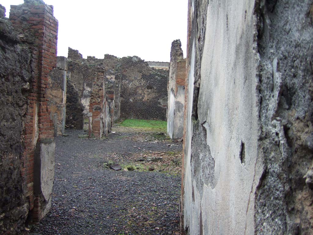 VI.14.42 Pompeii. December 2005. Looking east across atrium and small tablinum towards garden area at rear.
According to Jashemski, the small garden at the right rear of the house, excavated in 1846, was visible from the entrance doorway through the atrium and tablinum.
It had a covered passageway on the west side. The triclinium to the north of the garden had a wide window looking into the garden.
See Jashemski, W. F., 1993. The Gardens of Pompeii, Volume II: Appendices. New York: Caratzas. (p.151)