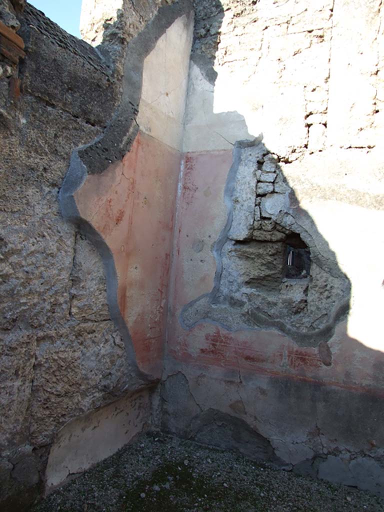 VI.14.43 Pompeii. December 2007. Room 2, north-west corner of bedroom or cubiculum on north side of entrance.
According to Bragantini, the floor of this room would have been of cocciopesto with crosses of white tesserae around a centre made of black tesserae.
On the north wall, the lower dado would have been painted black, the III style middle zone was painted red, with panels divided by painted candelabra.
A cornice of stucco was on the upper wall.
On the west wall with the bed recess, the dado was painted red, as were the two side panels which were separated from the central panel by painted candelabra.
The central panel of the west wall showed a painting of Ariadne abandoned by Theseus, now faded and vanished, see Helbig 1219 for description.
See Bragantini, de Vos, Badoni, 1983. Pitture e Pavimenti di Pompei, Parte 2. Rome: ICCD. (p.300, cubicolo ‘11’) 
See Helbig, W., 1868. Wandgemälde der vom Vesuv verschütteten Städte Campaniens. Leipzig: Breitkopf und Härtel (1219).