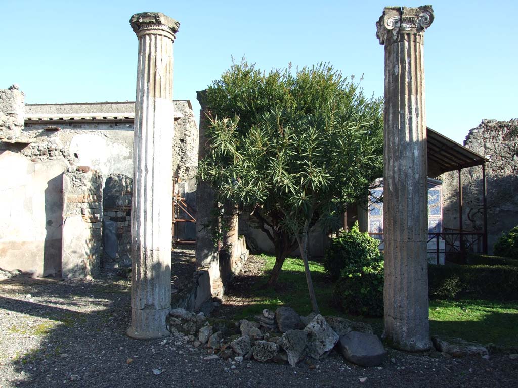 VI.14.43 Pompeii.  December 2007. North-west corner of the peristyle, with corridor to rooms at rear of the house on the north side, on left.
According to Jashemski, the portico was supported by four fluted columns joined by a low wall.
See Jashemski, W. F., 1993. The Gardens of Pompeii, Volume II: Appendices. New York: Caratzas. (p.151)