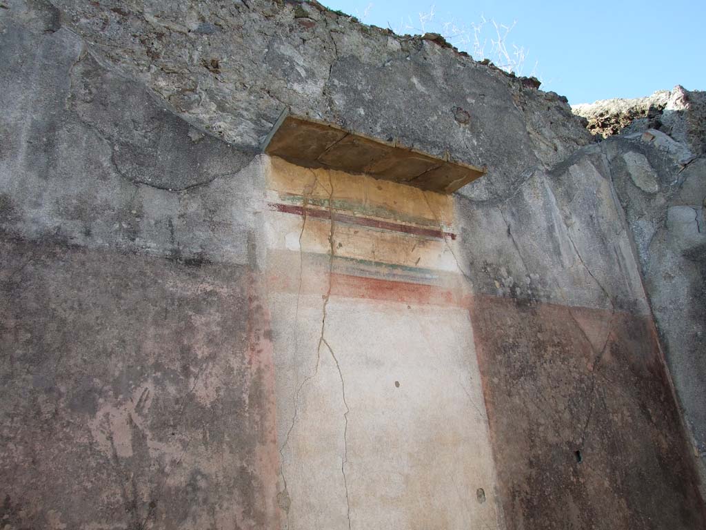 VI.14.43 Pompeii. December 2007. Room 16, west wall of exedra.
According to Bragantini, the west wall would have had a black dado.
The middle zone of the wall had a painting in the central aedicula panel, which was on a white background.
The side panels were red. The upper zone of the wall was white.
See Bragantini, de Vos, Badoni, 1983. Pitture e Pavimenti di Pompei, Parte 2. Rome: ICCD. (p.303, ambiente ‘19’) 
According to Bragantini, the brief tiled roof had not been sufficient to protect the painting (a mythological landscape with countryside, showing perhaps, according to Warscher “The fall of Icarus”) which was in the centre of the west wall.
See Carratelli, G. P., 1990-2003. Pompei: Pitture e Mosaici: Vol. V. Roma: Istituto della enciclopedia italiana, (p. 464).