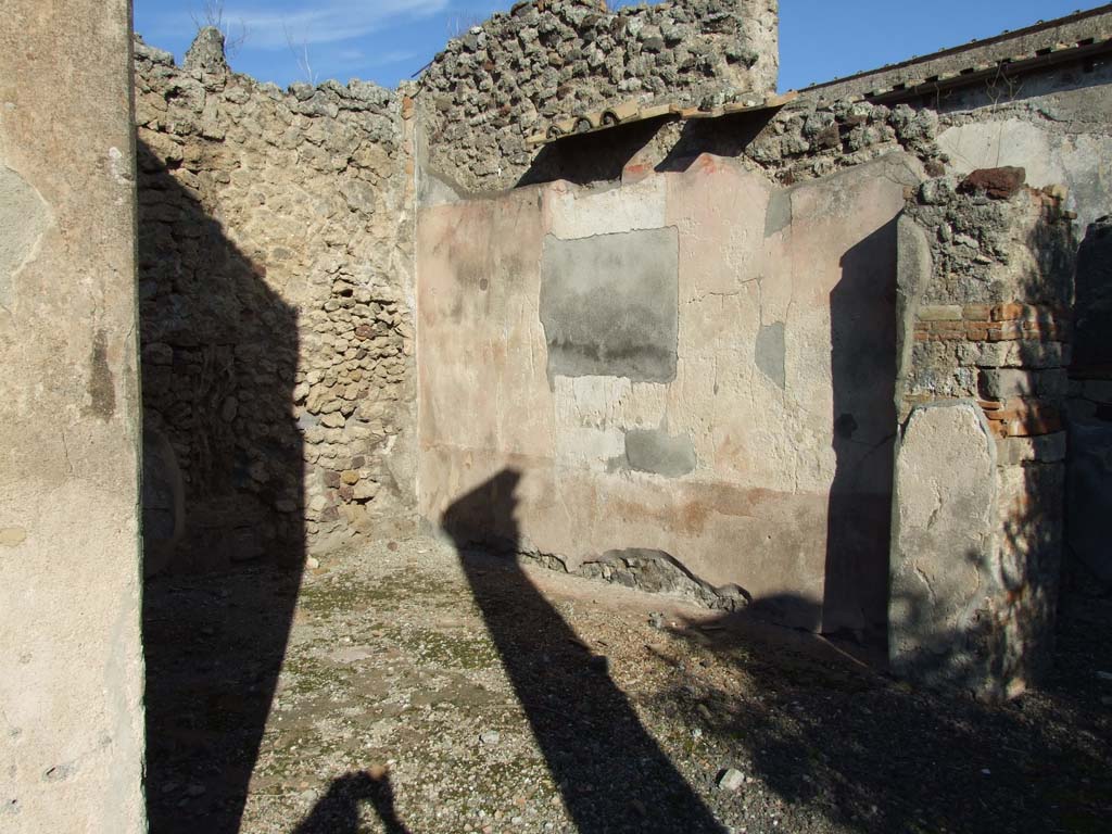 VI.14.43 Pompeii. December 2007. Doorway to room 16, exedra on north side of peristyle. Looking towards east wall.
According to PPM, the painting of Pindar and Corinna was found on the east wall.
Above a black zoccolo, the middle zone of the wall had a central aedicula with a red panel on either side. 
At the centre was the wide gap left by the detachment of the central part of the painting, showing Pindar and Corinna (Helbig 1379, NAP inv. 9269).
See Carratelli, G. P., 1990-2003. Pompei: Pitture e Mosaici. Vol.5. Roma: Istituto della enciclopedia italiana, (p.463). 
According to Schefold (1957) the painting was found on the north wall. 
Schefold said in 1962, that the painting had been transferred to Naples Archaeological Museum, Pindar, Myrtis and Corinna.
See Schefold, K., 1962. Vergessenes Pompeji. Bern: Francke. (Pl. 57, 2) 
According to Richardson, the wall painting of Pindar and Corinna, found on the north wall, had the inventory number NAP 9269.
He also gave the Helbig reference as Helbig 1379.
See Richardson, L., 2000. A Catalog of Identifiable Figure Painters of Ancient Pompeii, Herculaneum. Baltimore: John Hopkins. (p.67). 
However, NAP 9269 is a painting of Bacchus and Silenus, from VII.7.32, and according to Elia the painting of Pindar, Myrtis and Corinna was inventory number: s.n (senza numero).
See Elia, O. (1932): Pitture murali e mosaici nel Museo Nazionale di Napoli. Rome: La Libreria dello Stato. (p.14, no.5: Gara di citaredo).
According to Helbig the exedra, left from peristyle, contained a painting of: Gods (deification of) of Homer. This had the same number as the above.
See Helbig, W., 1868, Wandgemälde der vom Vesuv verschütteten Städte Campaniens. Leipzig: Breitkopf und Härtel.  (1379).