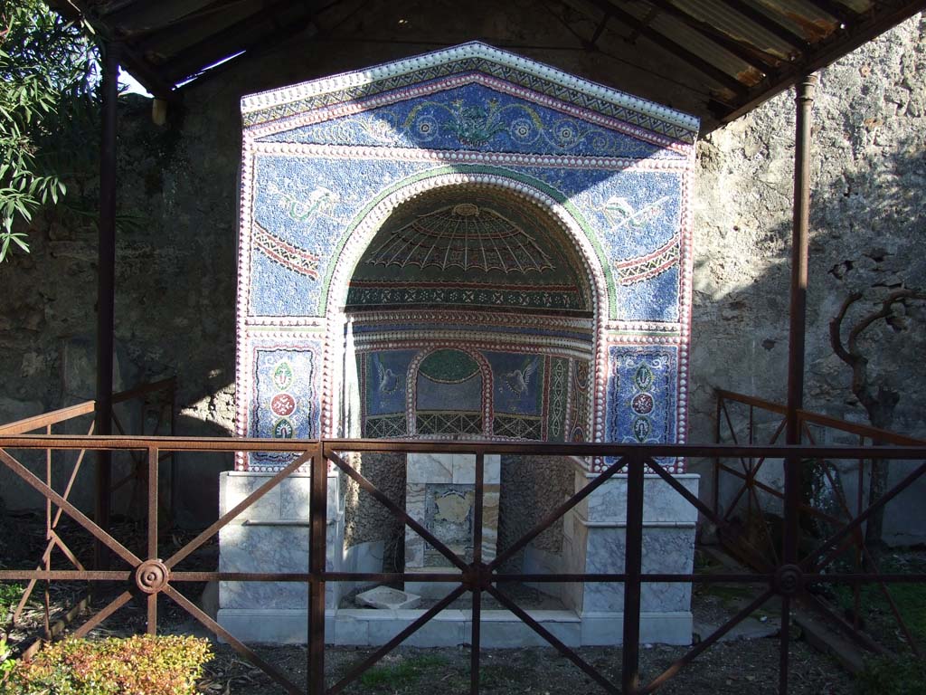 VI.14.43 Pompeii. December 2007. Room 14, mosaic fountain in garden area.  
According to Jashemski, when the fountain was excavated there was a pedestal in the niche, in which stood a statue of Mars.
This is now in Naples Archaeological Museum, inventory number 126249, Ruesch: 1924.
Below on the pedestal was a mask of a woman, which was bordered with mosaic and coloured marble, from which the water jetted.
See Jashemski, W. F., 1993. The Gardens of Pompeii, Volume II: Appendices. New York: Caratzas. (p.152, inc. photo of statue of Mars, fig.164)