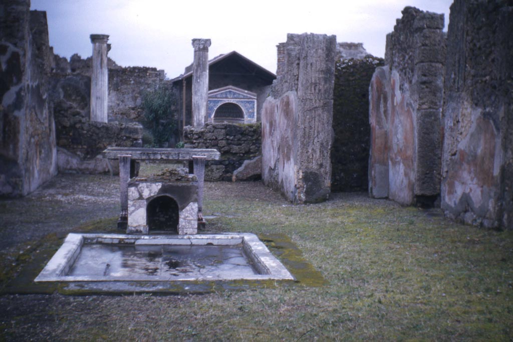 VI.14.43 Pompeii. February 1952. Room 1, looking east across impluvium in atrium, towards tablinum, and garden area.
Photo courtesy of John Vanko. His father took this photo in 1952, identical to the one above.