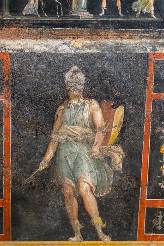 VI.15.1 Pompeii. March 2023.
Lower east wall, painted panel of Amazon armed with a shield. beneath panel of a stag being sacrificed to Diana.
Photo courtesy of Johannes Eber.