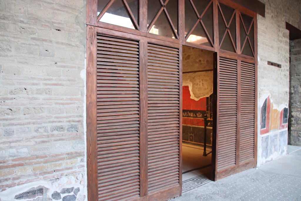 VI.15.1 Pompeii. October 2023.
Looking north-east across north portico to doorway to the “Cupids’ room”, (PPM - room q). Photo courtesy of Klaus Heese.