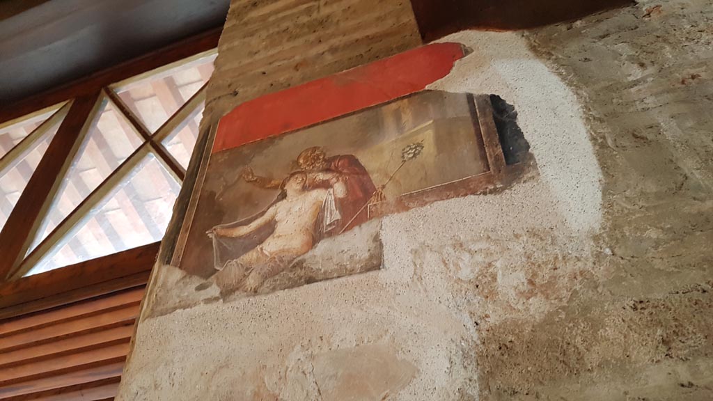 VI.15.1 Pompeii. August 2023.
Wall painting of Silenus and Hermaphroditus on west side of doorway of south wall. Photo courtesy of Maribel Velasco.