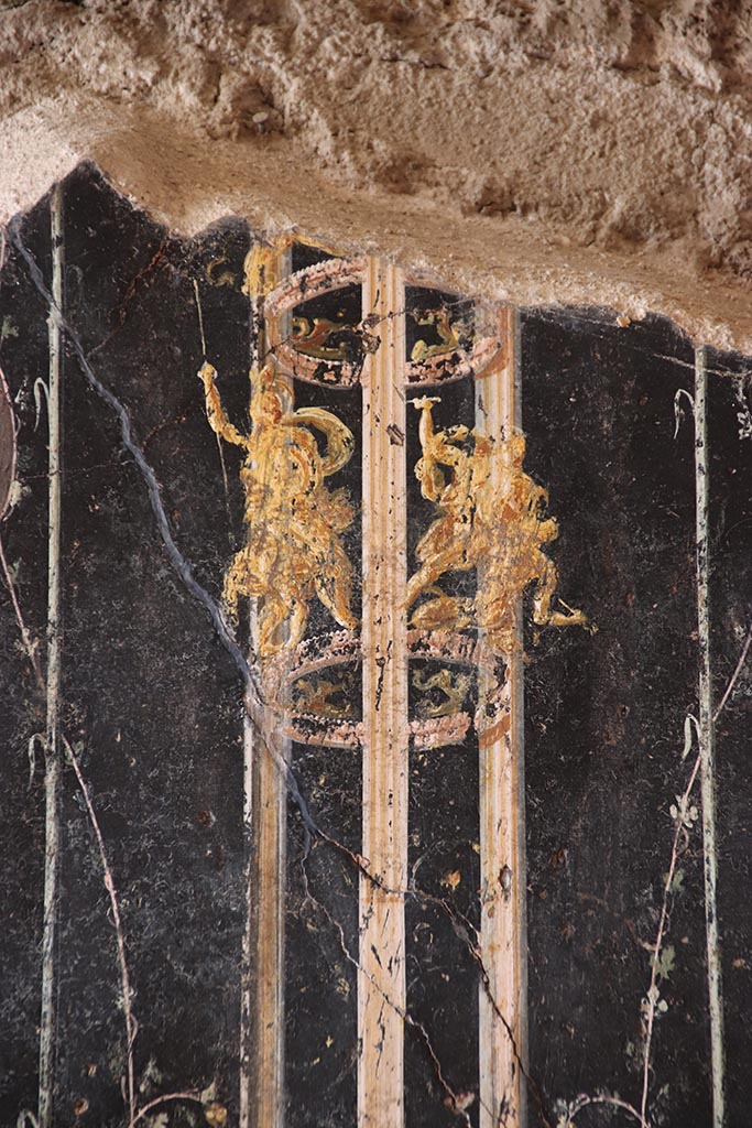 VI.15.1 Pompeii. October 2024.
Detail from upper panel on west wall on south side of panel with Cupid’s buying and selling wine.
Photo courtesy of Klaus Heese.