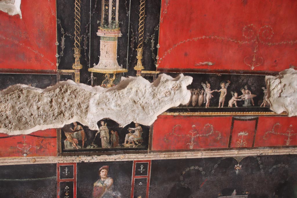 VI.15.1 Pompeii. October 2023.
West wall, detail from south side of central panel with Cupid’s buying and selling wine. Photo courtesy of Klaus Heese.