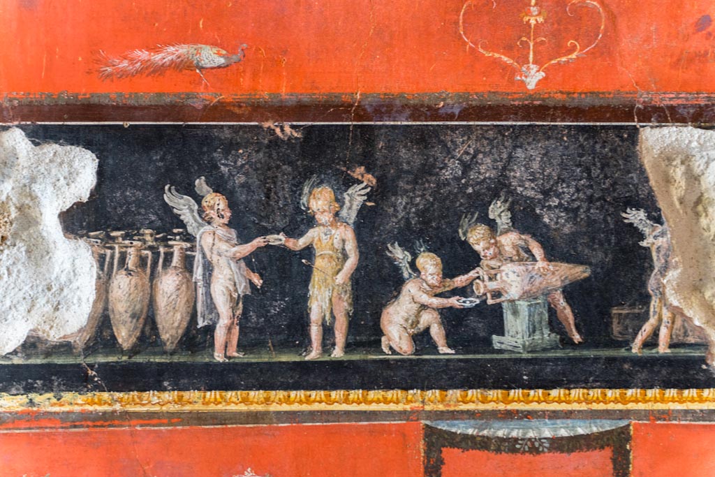 VI.15.1 Pompeii. March 2023.
West wall at north end, with painted panel of cupids buying and selling wine. Photo courtesy of Johannes Eber.