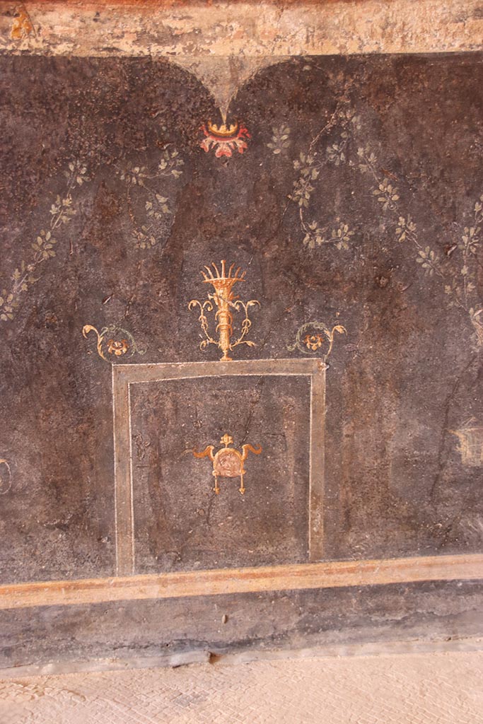 VI.15.1 Pompeii. October 2024.
Lower west wall at north end, detail from painted zoccolo. Photo courtesy of Klaus Heese.
