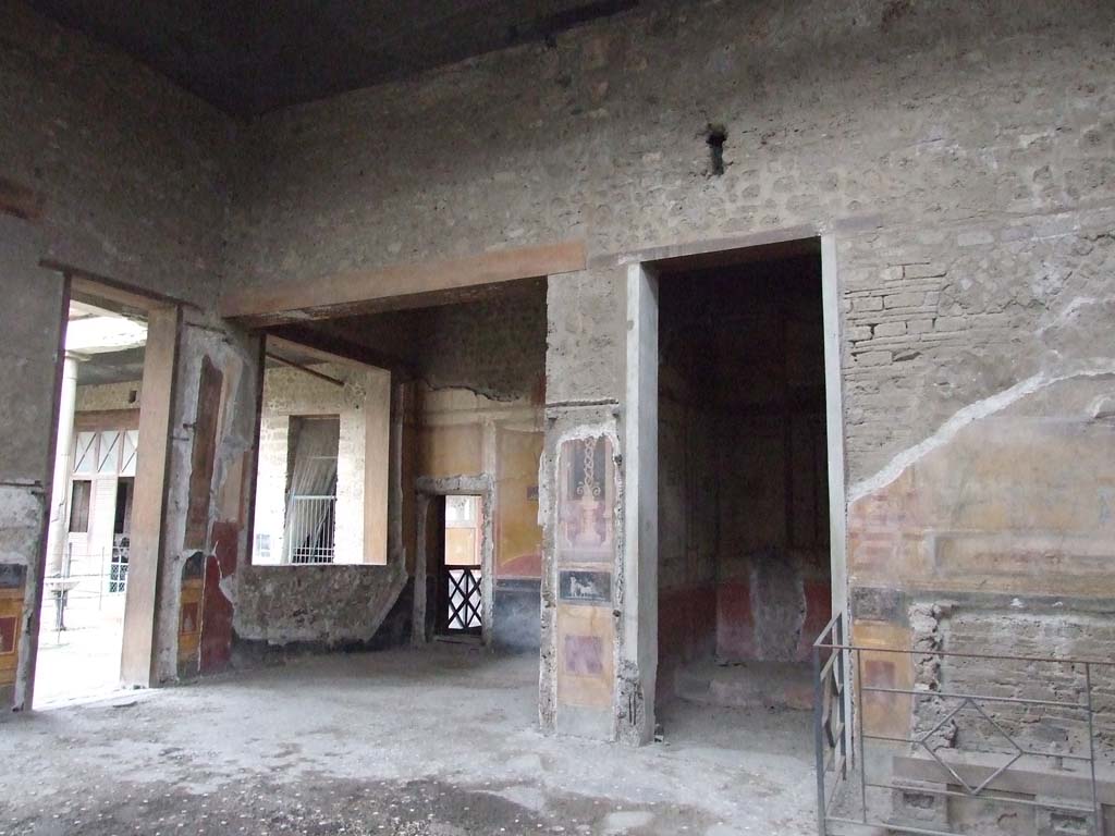 VI.15.1 Pompeii. December 2006. Looking towards north-west corner of atrium.
Doorways to ala (on left) and bedroom (on right) on north side of atrium.