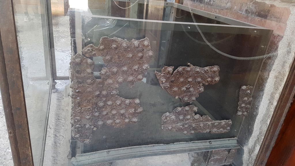 VI.15.1 Pompeii. August 2023. Looking east towards side of money-chest near south wall of atrium. Photo courtesy of Maribel Velasco.