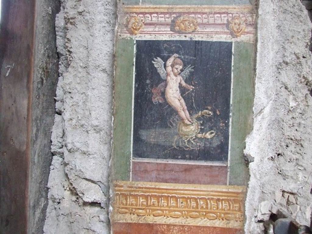VI.15.1 Pompeii. December 2006. Detail of painted pillar between Peristyle and Atrium showing Cherub or Cupid riding a crab.