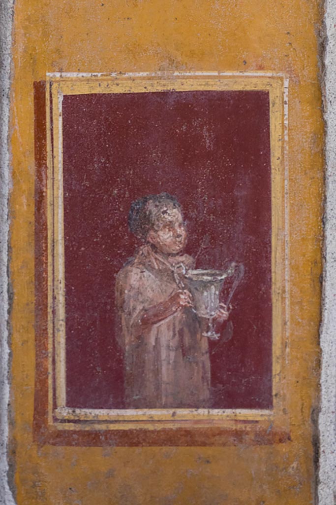 VI.15.1 Pompeii. March 2023.
Detail of painted panel on south end of lower west wall of atrium, leading onto peristyle.
Photo courtesy of Johannes Eber.