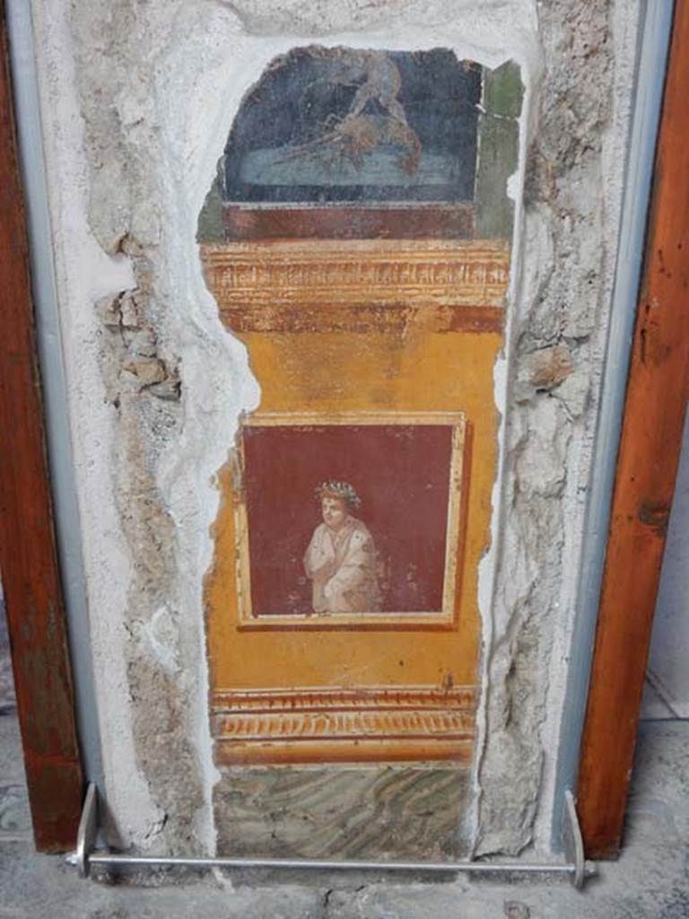 VI.15.1 Pompeii. May 2017.
Painted panel on north end of lower west wall of atrium, leading onto peristyle. Photo courtesy of Buzz Ferebee.