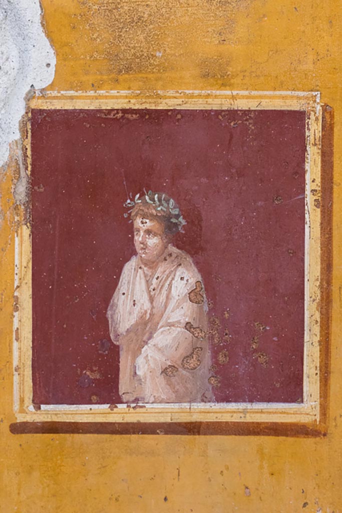 VI.15.1 Pompeii. March 2023.
Detail from painted panel on north end of lower west wall of atrium, leading onto peristyle.
Photo courtesy of Johannes Eber.