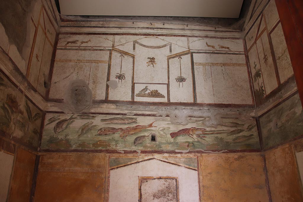 VI.15.1 Pompeii. October 2024. Looking east in bedroom towards frieze of fishes on upper east wall. Photo courtesy of Klaus Heese.