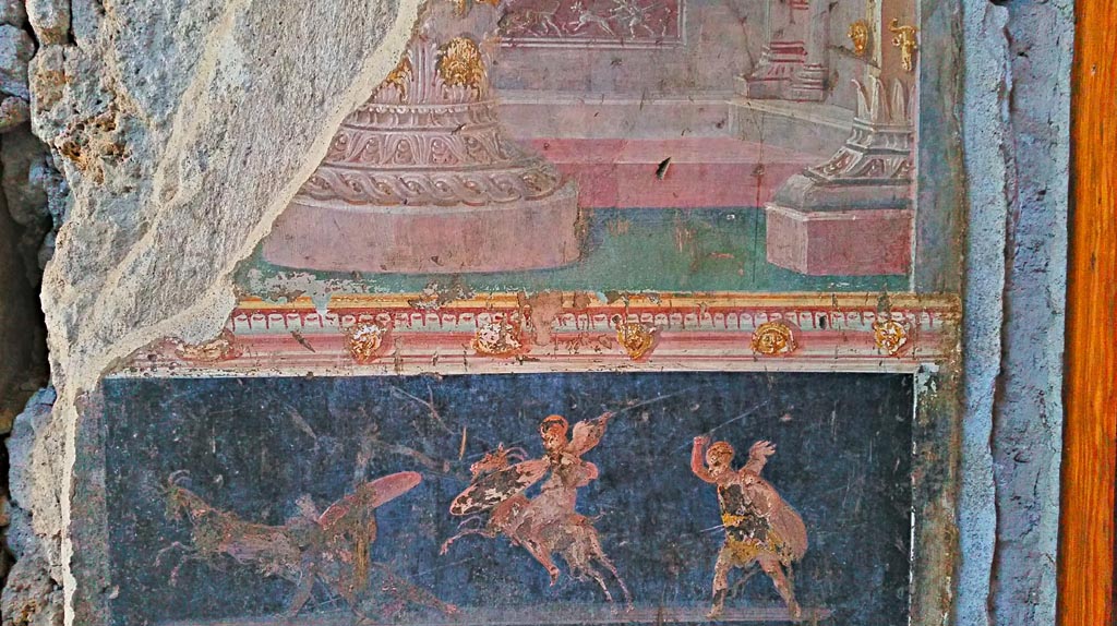 VI.15.1 Pompeii. December 2019.
East wall of atrium, detail of painted decoration between doorways to bedroom on left of main entrance and oecus on south side.
Photo courtesy of Giuseppe Ciaramella.