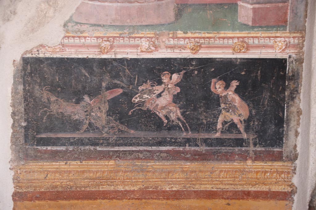 VI.15.1 Pompeii. October 2023.
East wall of atrium, detail of painted decoration from panel between cubiculum (d) and oecus (e). Photo courtesy of Klaus Heese.