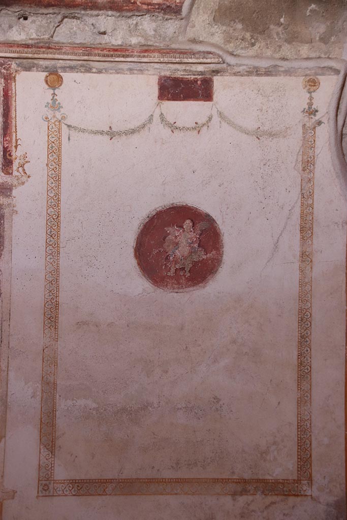 VI.15.1 Pompeii. October 2024.
Painted panel at north end of west wall of oecus. Photo courtesy of Klaus Heese.