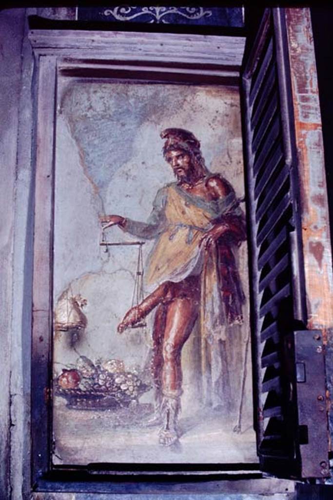 VI.15.1 Pompeii. 1968. Painting of a bearded Priapus in vestibule. On the right is the shutter of the lockable case in which this painting used to be enclosed. According to Wilhelmina the custodians with the keys could be persuaded to unlock the case, if presented with a suitable tip by the tourists. Photo by Stanley A. Jashemski.
Source: The Wilhelmina and Stanley A. Jashemski archive in the University of Maryland Library, Special Collections (See collection page) and made available under the Creative Commons Attribution-Non Commercial License v.4. See Licence and use details.
J68f1814