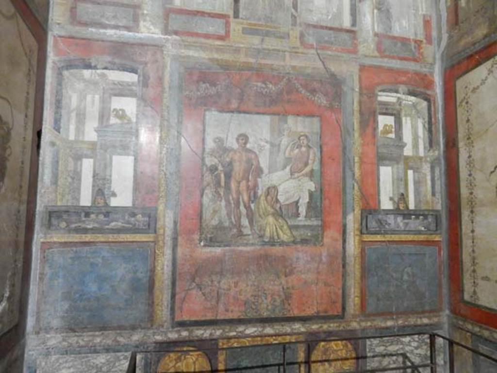 VI.15.1 Pompeii. May 2017. Looking towards the east wall, on either side of the central panel were painted panels. On the left (north side) painted food was shown, with mask above. On the right (south side) painted drinks were shown, with mask above. Photo courtesy of Buzz Ferebee.