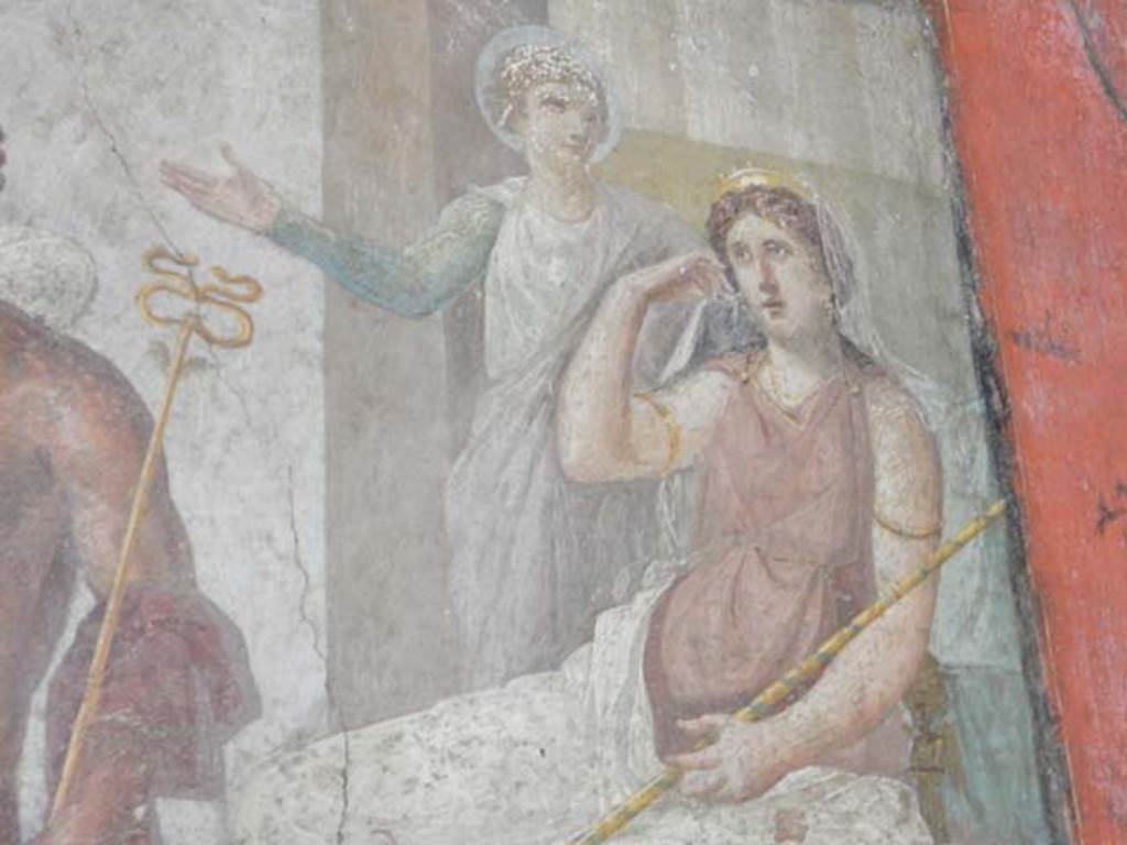 VI.15.1 Pompeii. May 2017. Detail of Juno and long stick/baton against right arm. Hera/Juno with gold crown and long sceptre is seated on her throne with Iris standing to her left, gesticulating.
Photo courtesy of Buzz Ferebee.