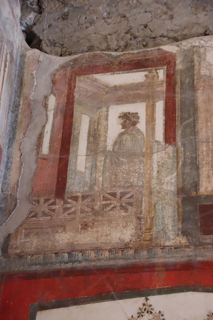 VI.15.1 Pompeii. October 2023.
Painted figure from upper south wall in the south-east corner. Photo courtesy of Klaus Heese.