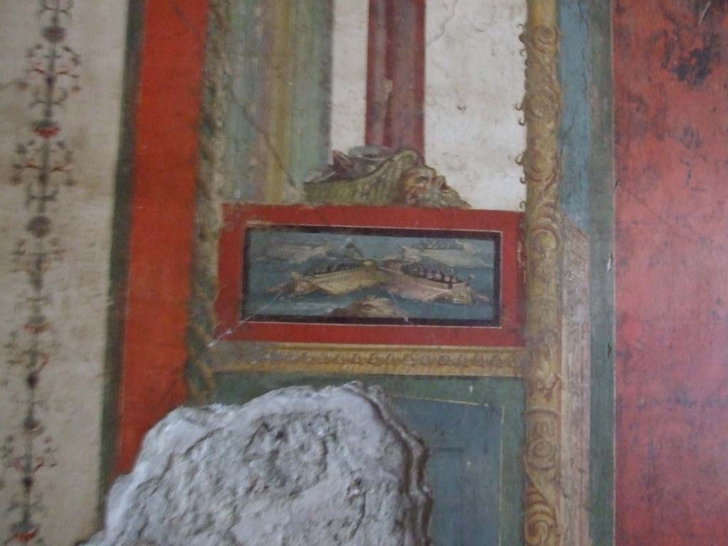 VI.15.1 Pompeii. December 2006.
South wall of exedra with wall painting of naval scene on east side of central painting, with basket and mask above.