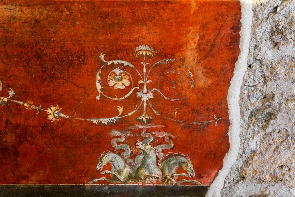 VI.15.1 Pompeii. March 2023.
Detail of painted decoration below central painting on south wall of exedra. Photo courtesy of Johannes Eber.