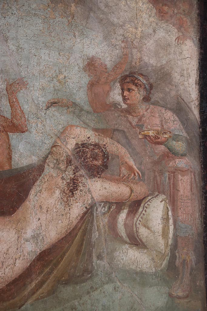 VI.15.1 Pompeii. October 2024.
Hypnos (the god of sleep) with golden dish in his hand watching over Ariadne, detail of central painting from south wall.
Photo courtesy of Klaus Heese.