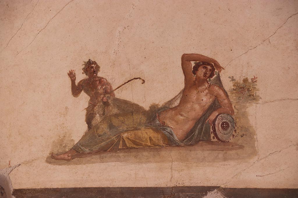 VI.15.1 Pompeii. October 2024.
Detail of panel showing Pan discovering Hermaphrodite from above door in south wall. Photo courtesy of Klaus Heese.