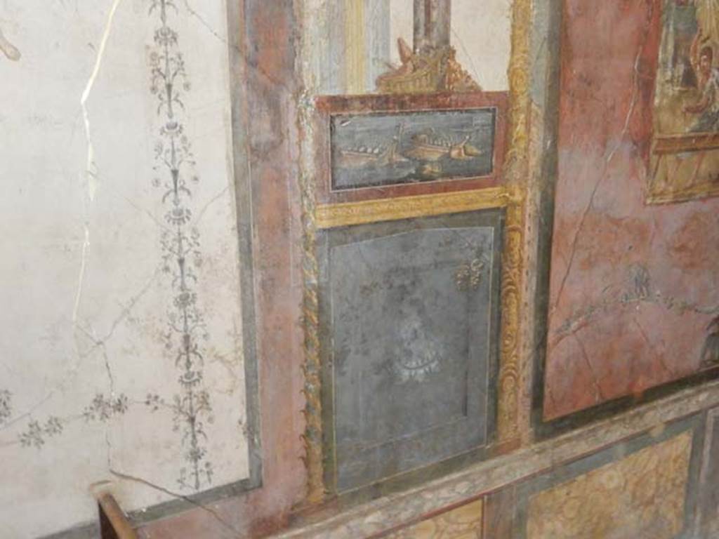 VI.15.1 Pompeii. May 2017. North wall of exedra on west side of central painting, wall painting of naval scene, with basket and mask above. Photo courtesy of Buzz Ferebee.
