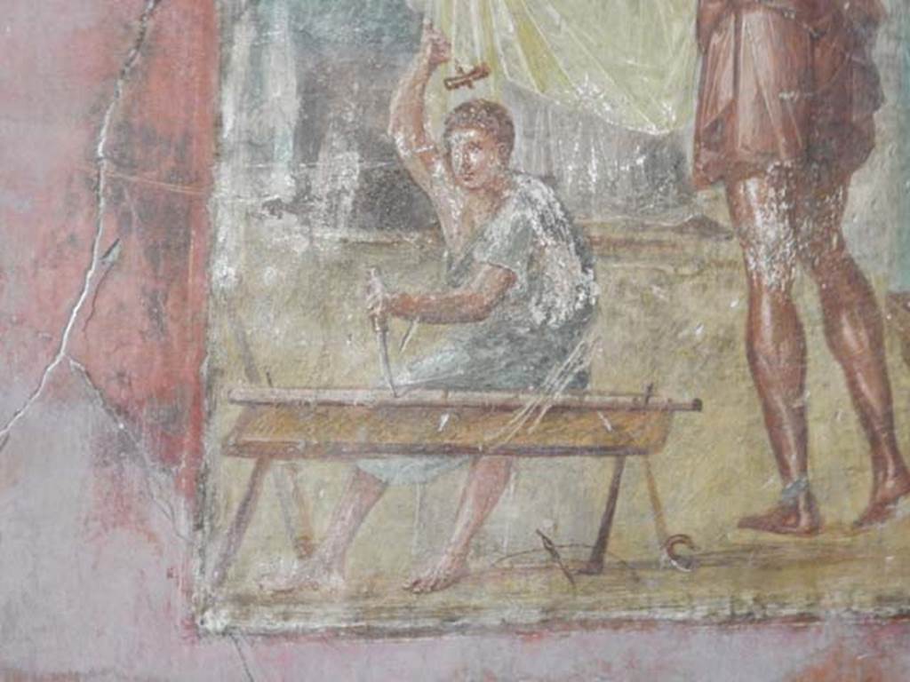 VI.15.1 Pompeii. May 2017. Detail from central painting showing Daedalus’s helper carrying out work with hammer and chisel. Photo courtesy of Buzz Ferebee.