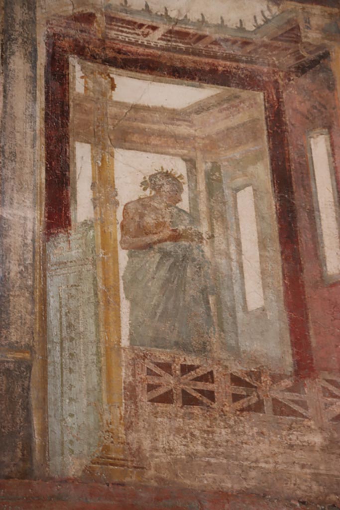 VI.15.1 Pompeii. October 2023.
Upper north wall of exedra at east end, detail of painted figure. Photo courtesy of Klaus Heese.
