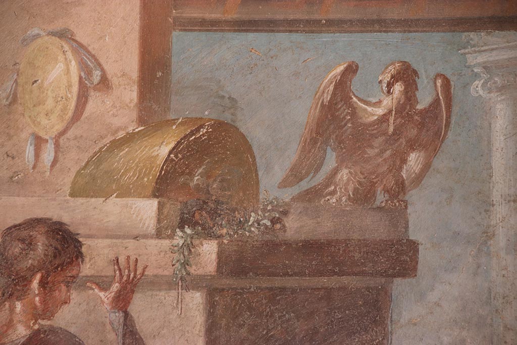 VI.15.1 Pompeii. October 2024.
North wall of exedra, upper centre showing Zeus, father of Hercules, as an eagle. Photo courtesy of Klaus Heese.